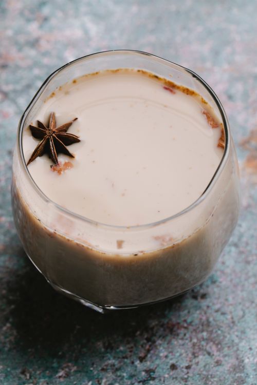 Free From above of glass of milky horchata with cinnamon and anise placed on table Stock Photo
