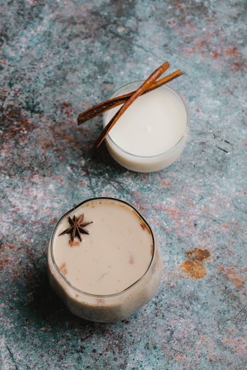 Free Top view of milky cocktails with spice decorated with anise star and cinnamon sticks served on table Stock Photo