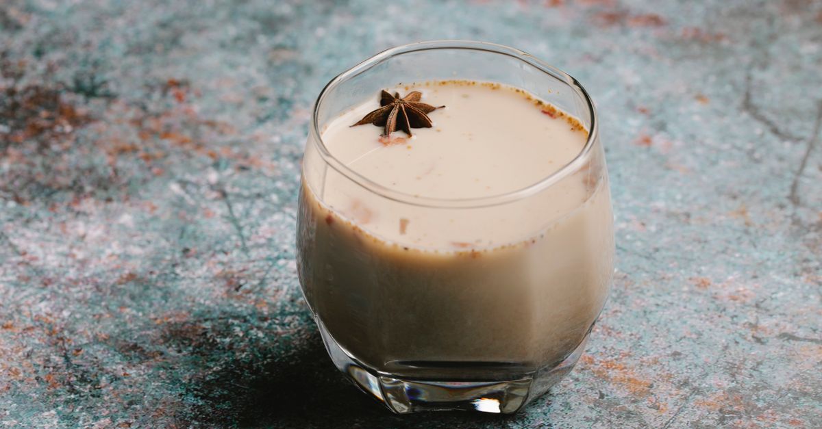 From above of tasty sweet cocktail with milk and spice served on table