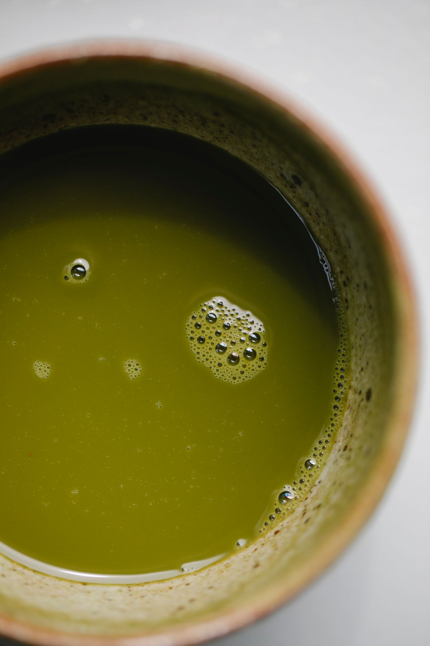 A bowl of vibrant green matcha seen from above.