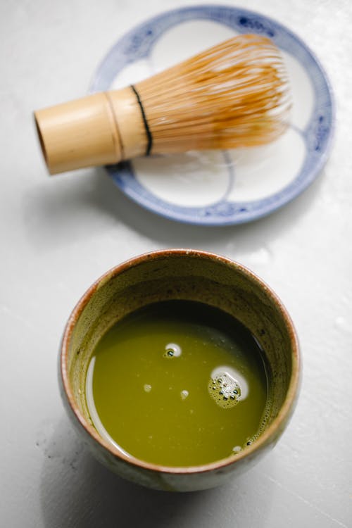 Mixture of green tea in ceramic dishware