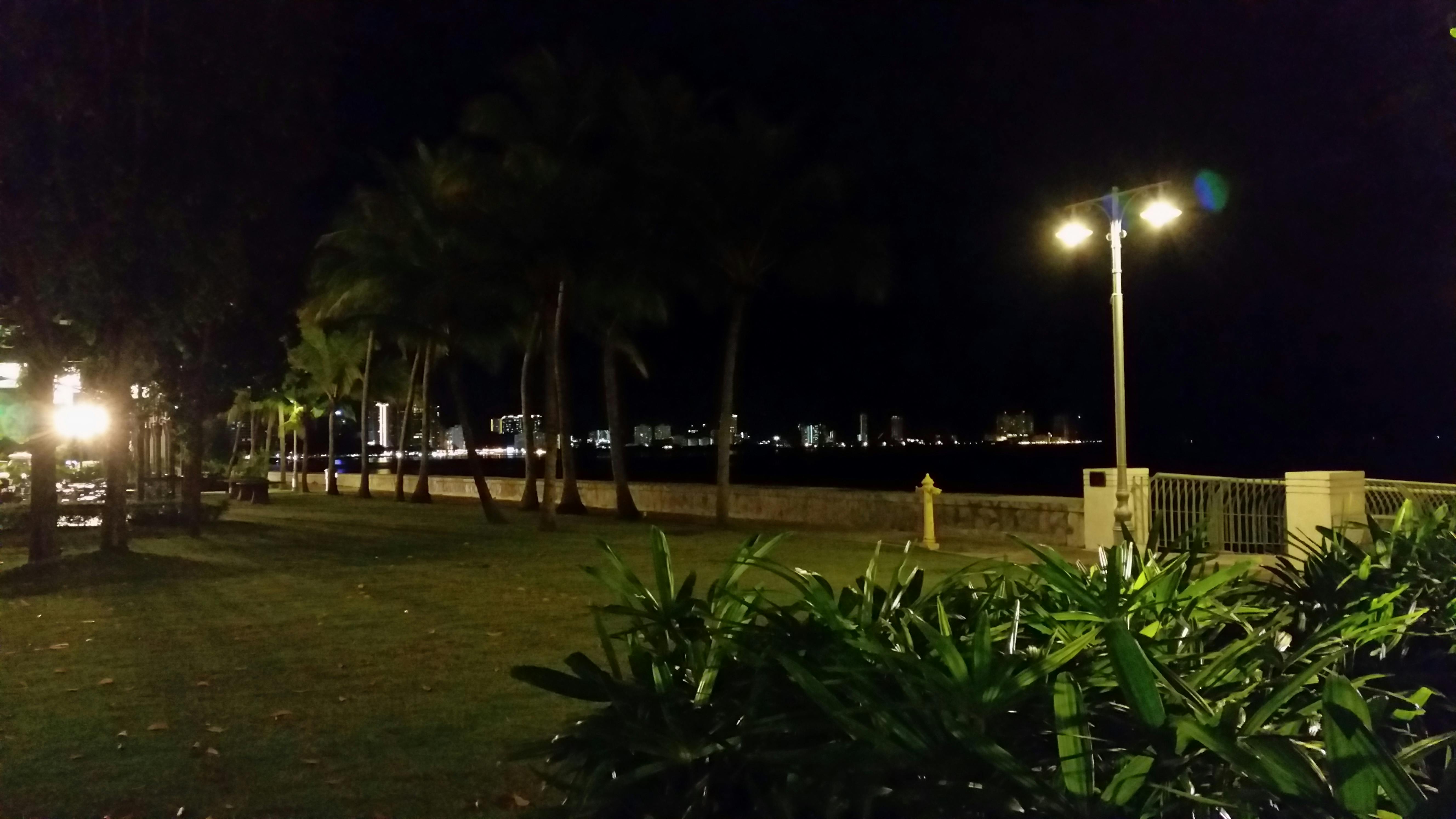 Person pouring tomato juice into a glass with fresh tomatoes nearby