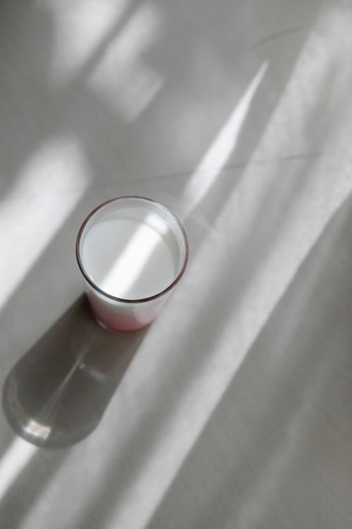 Free High angle of round shaped glass with tasty protein shake on table with shadows in sunlight Stock Photo