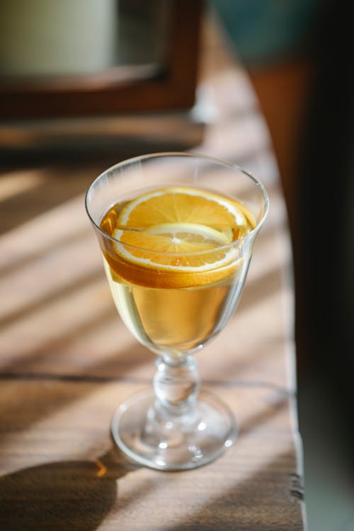 Alcoholic cocktail with orange in glass