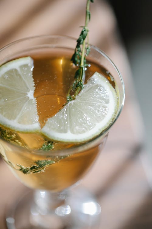 Transparent glass of cocktail with lemon