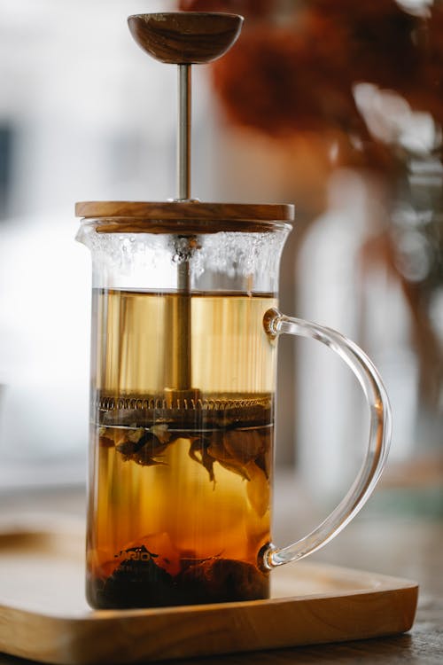 Glass French press teacup with brewing aromatic tea