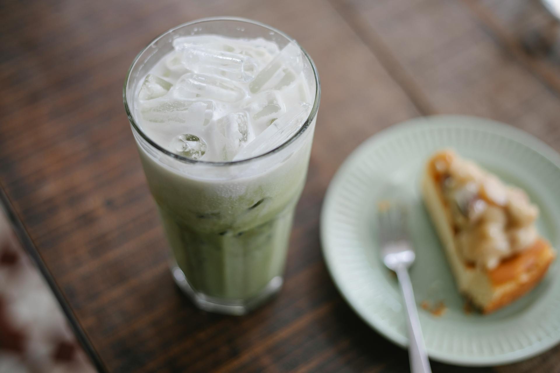 Tasty iced matcha latte served with sweet pie
