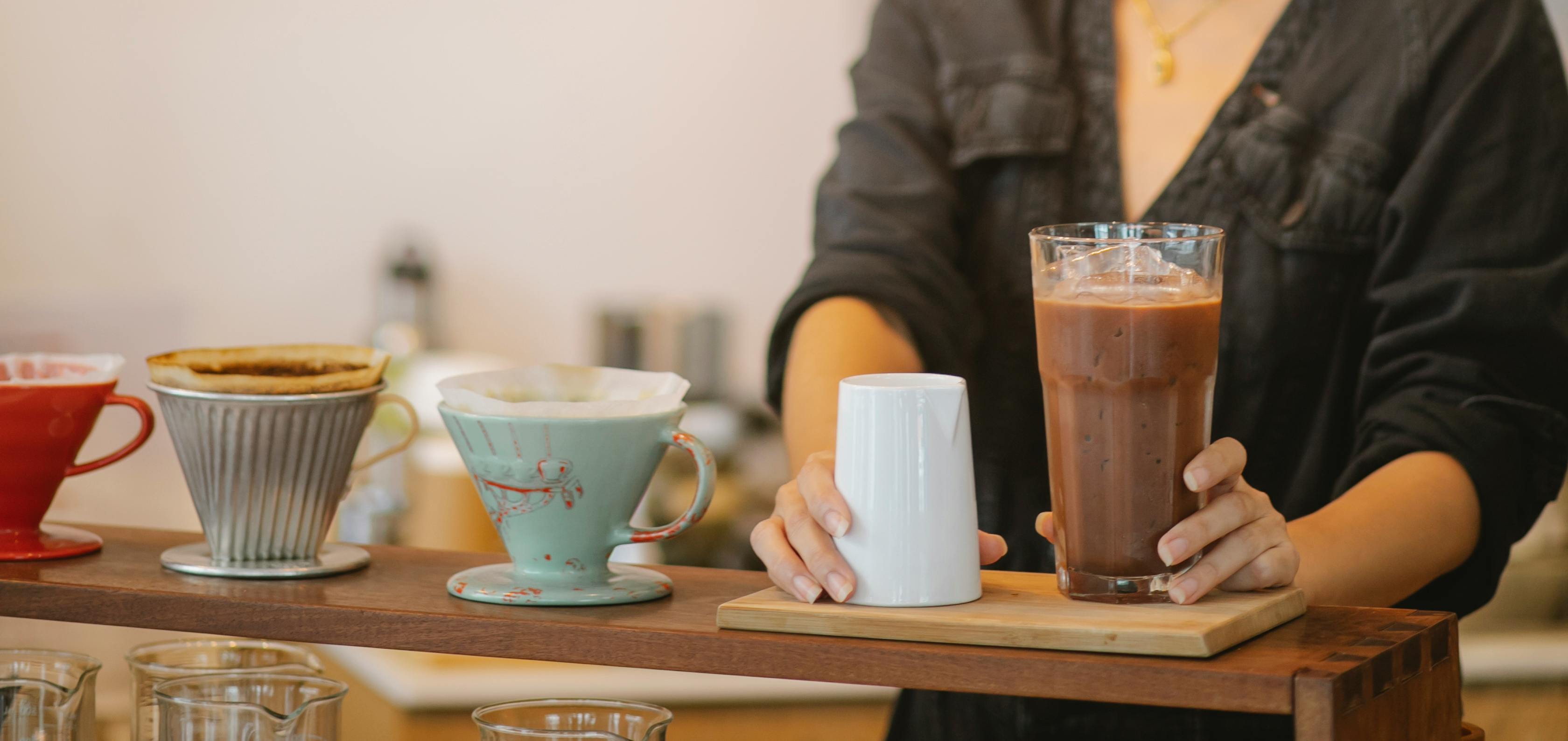 A Person Holding a Glass of Iced Coffee
