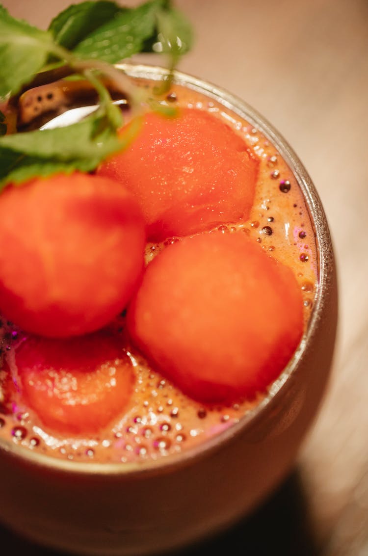 Glass Of Sweet Mocktail Garnished With Fruit Balls