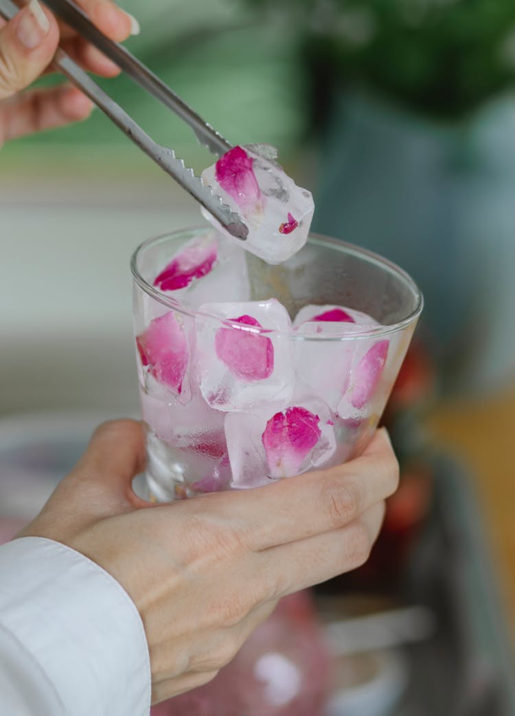 Crop Woman Putting Ice Cubes In Glass