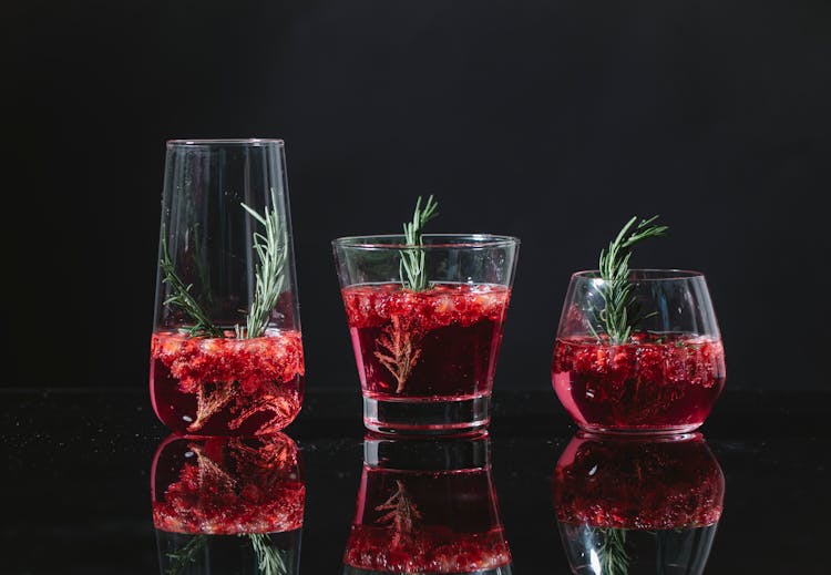 Different Glasses With Red Cocktails