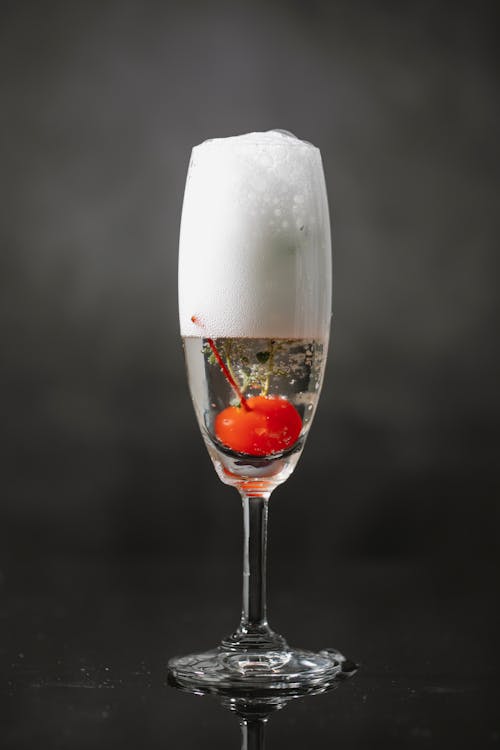 Glass of sparkling champagne with berry