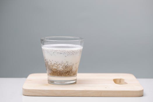 A delicious chia seed pudding in a glass on a wooden board, perfect for a healthy snack.