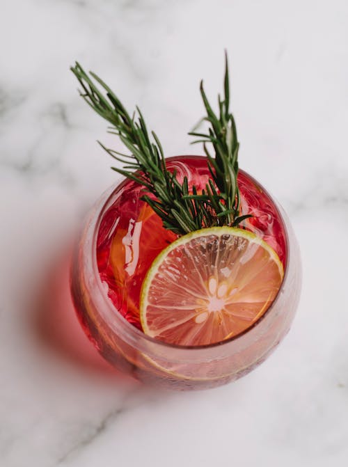 Free Glass of refreshing drink with grapefruit and rosemary Stock Photo