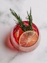 Glass of refreshing drink with grapefruit and rosemary