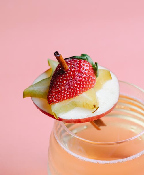 Fruits pieces on cinnamon stick decorating drink