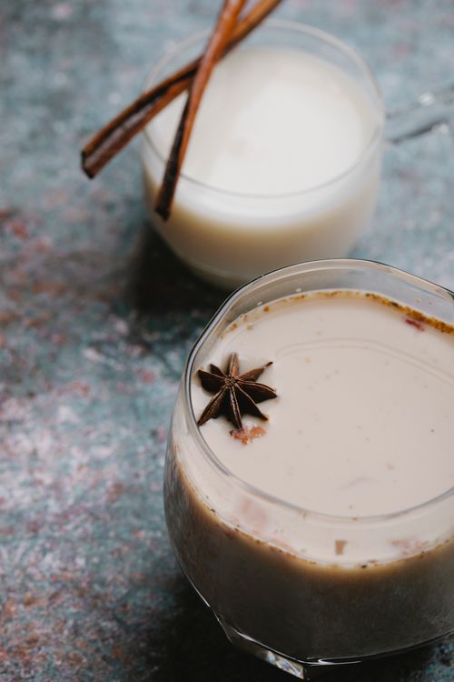 Free From above of glasses of latte with anise and cinnamon placed near each other Stock Photo