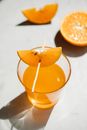 From above glass transparent glass full of drink decorated with piece of drink on thin wooden stick