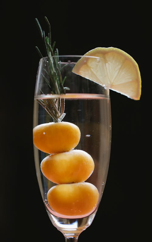 Refreshing cocktail with fruits in glass