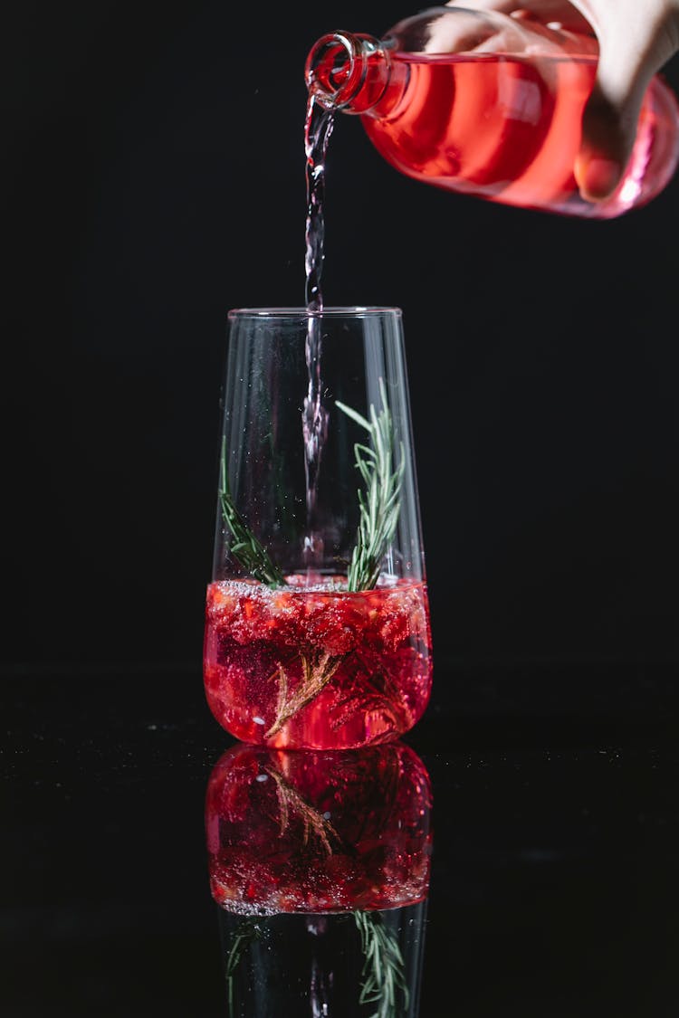 Crop Barman Pouring Drink Into Glass