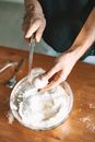 Close-Up Shot of a Person Cracking an Egg Using a Knife