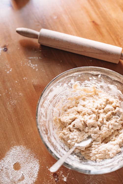 Free Close-Up Shot of a Dough in a Bowl beside a Rolling Pin Stock Photo