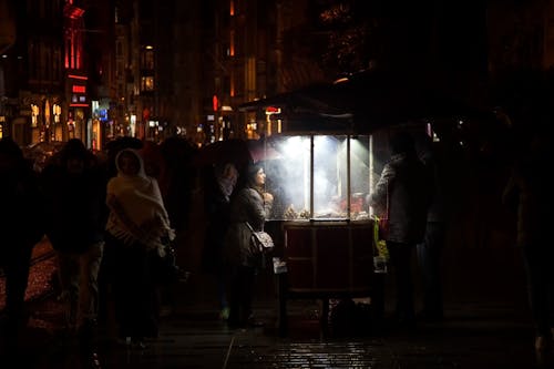 Free People Walking Through an Old Town at Night  Stock Photo