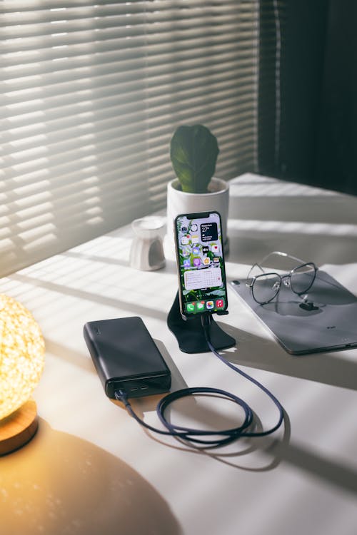 Free Charging an iPhone on a Power Bank Stock Photo