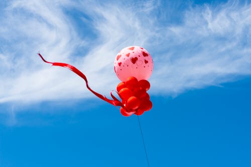 Pink Balloon with Heart Design Under a Cloudy Sky