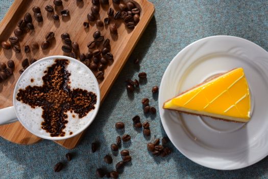 A captivating overhead shot of a latte with artistic topping, lemon tart, and coffee beans.