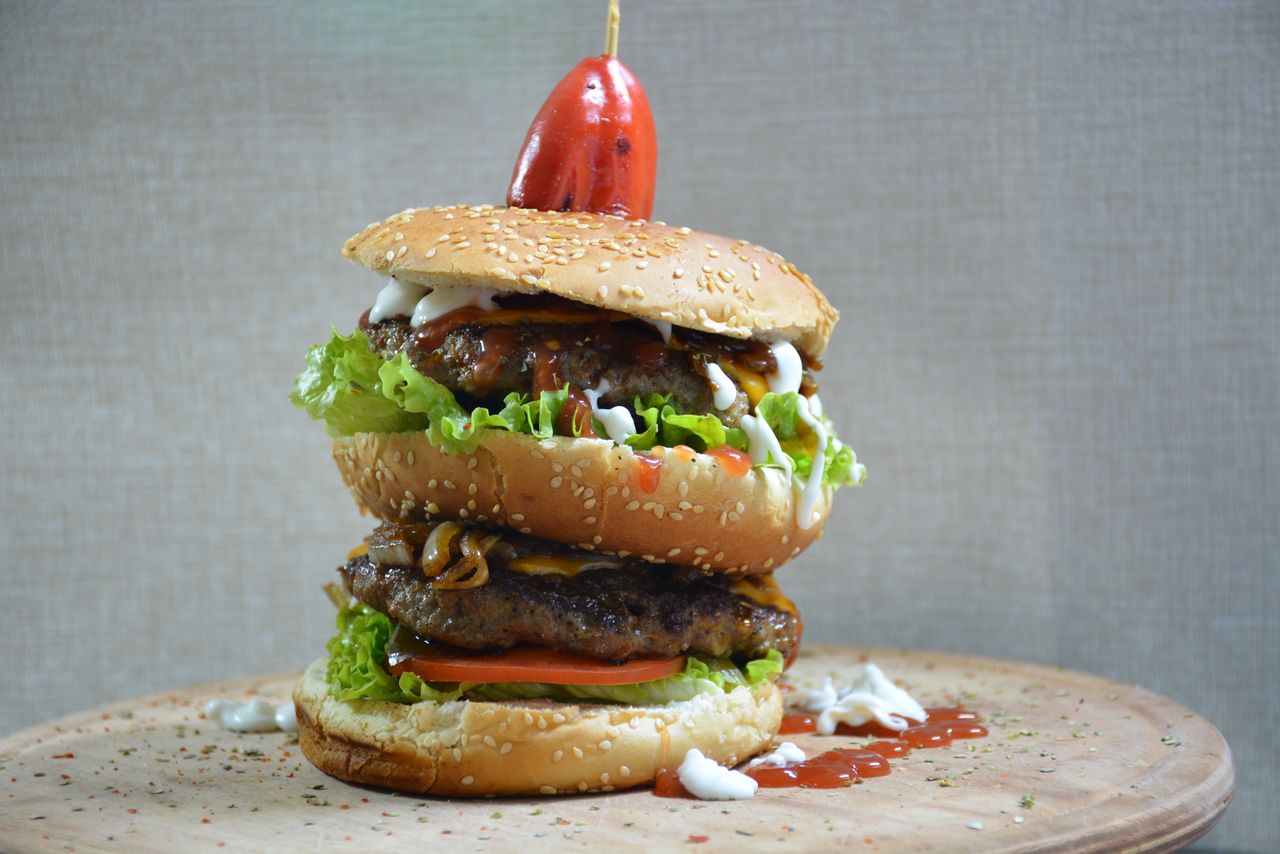 a mouthwatering double cheeseburger with fresh toppings and a sesame s