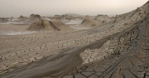 Free View Of Flow Of Mud From Volcano and Mud Cracks Stock Photo