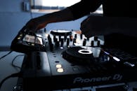 Person Playing Black and White Dj Controller