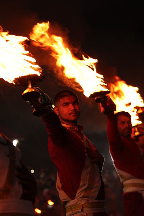 Men Holding Burning Pots during a Traditional Ritual 