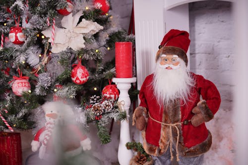 Santa Claus Figurine Beside a Christmas Tree