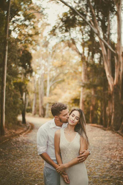 Man Kissing Woman in Shallow Photo