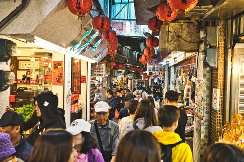 Free Lively street market alley filled with people and shops in New Taipei City, Taiwan. Stock Photo