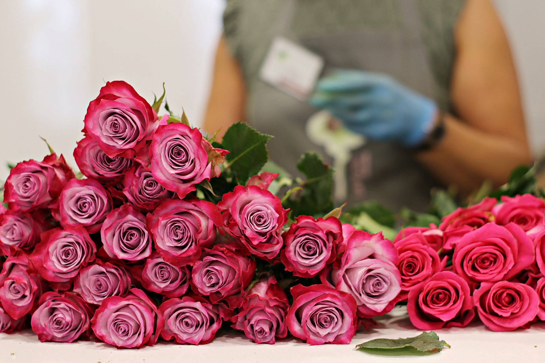 Florist arranging roses and seasonal flowers for Florida delivery