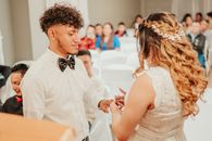 Loving ethnic newlyweds exchanging wedding rings