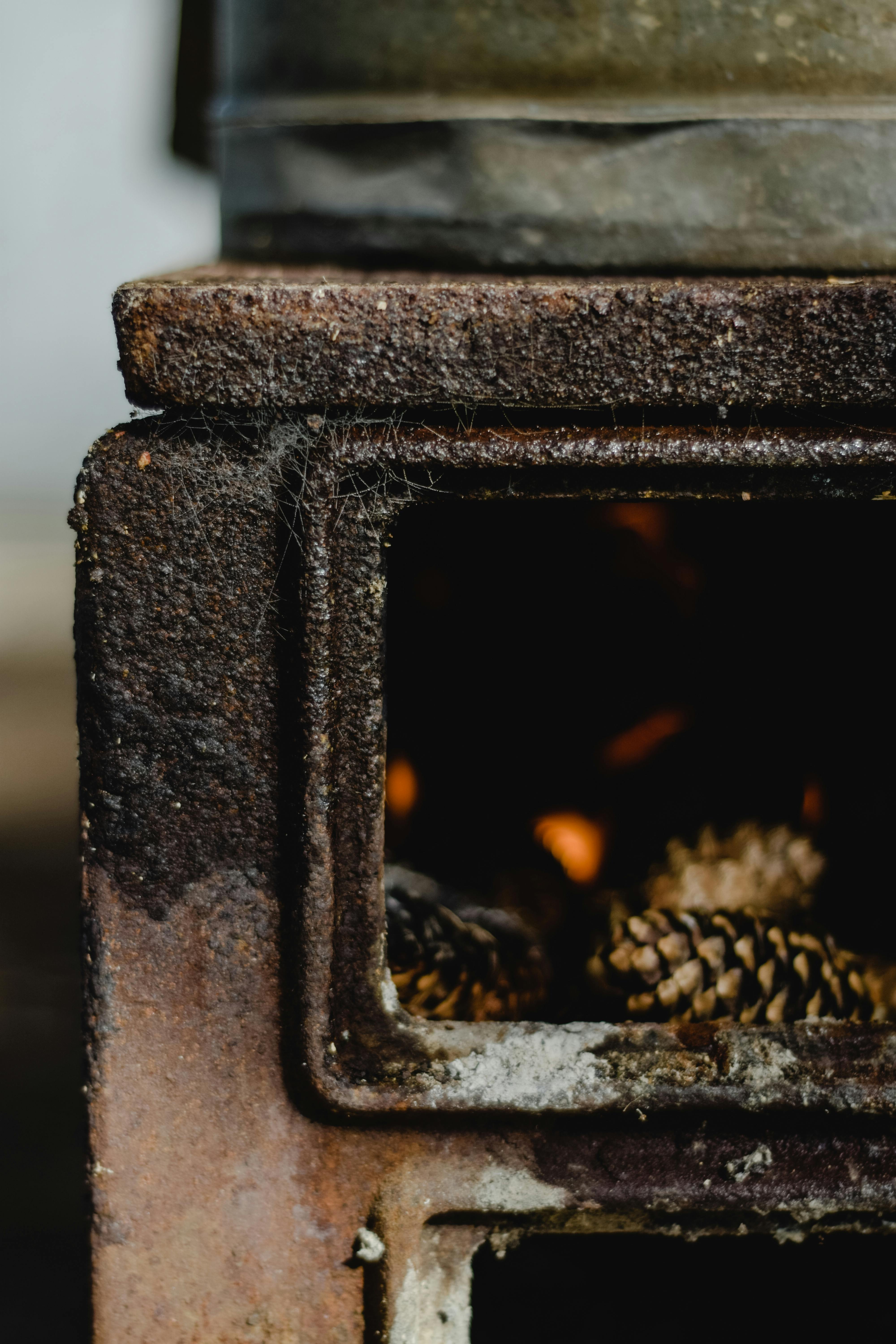 Rusty Stove with Burning Pinecones · Free Stock Photo