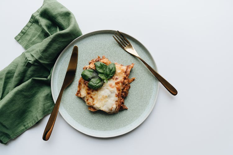 Cheesy Baked Lasagna Slice In An Earthenware 