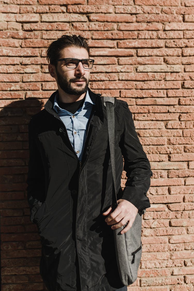 Man In Black Jacket Carrying A Messenger Bag