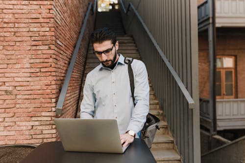 Man Standing Beside a Staircase