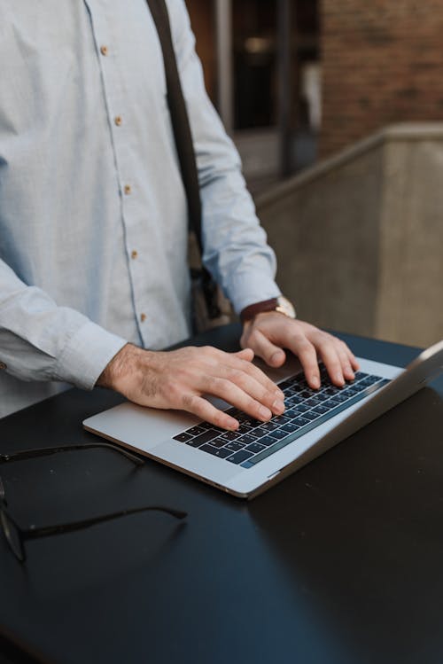 A Person's Hands on a Laptop