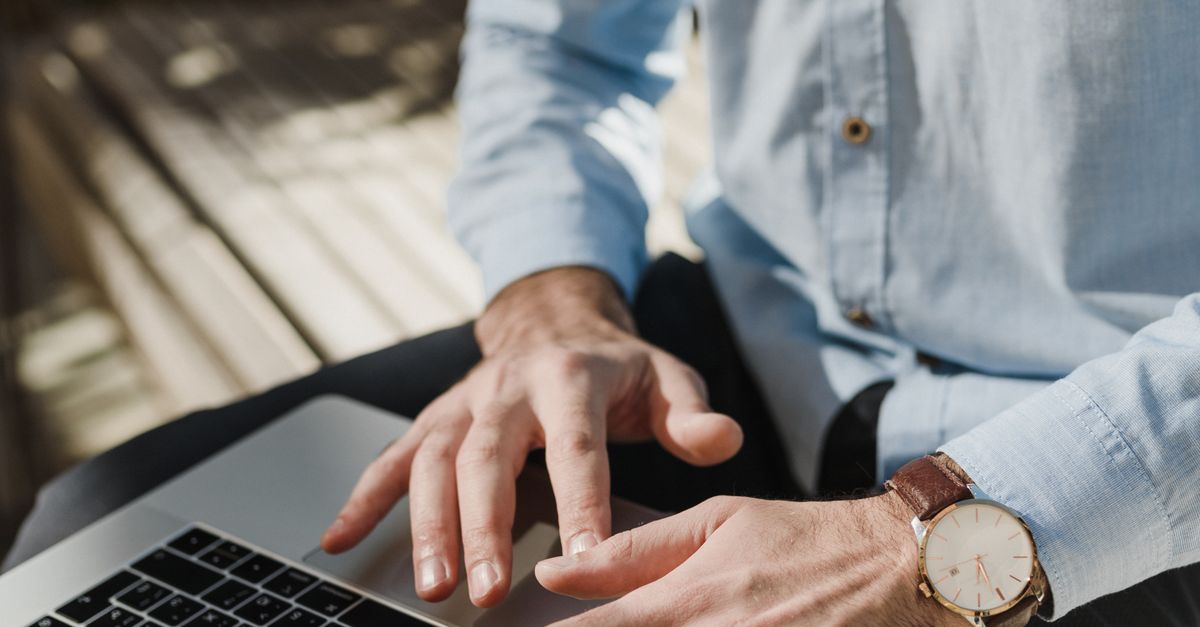 Crop Photo of Man Using Macbook Pro · Free Stock Photo