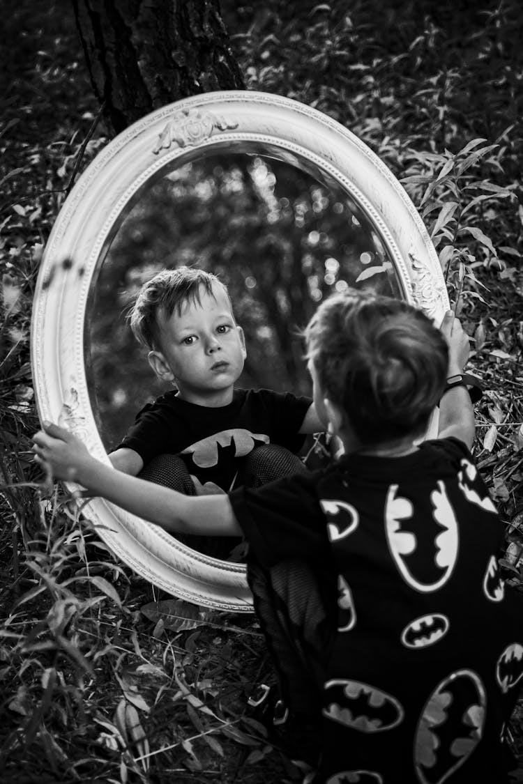 Grayscale Photo Of A Boys Looking At The Mirror