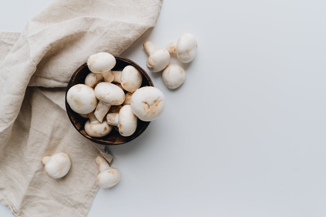 Free Mushrooms on a Bowl Beside a Hand Towel Stock Photo