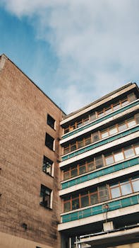 Low-angle view of a residential building against a blue sky in Sankt-Peterburg, Russia.