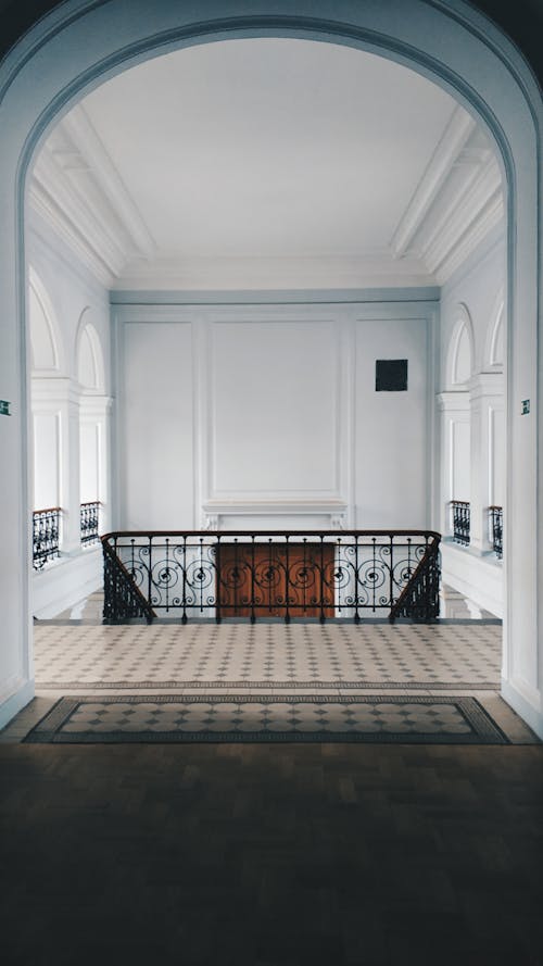 Interior of classy mansion hallway with ornamental stairway