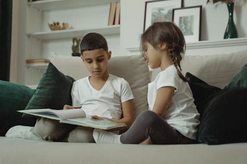 Kids Reading a Book on the Couch